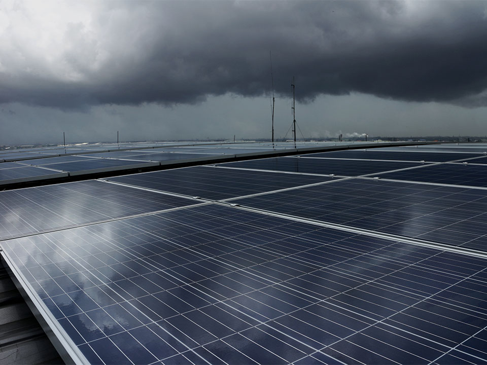 Solar panels with a dark stormy background