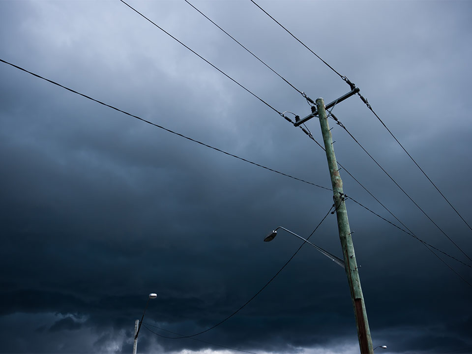 Powerlines with dark storm clouds in the background